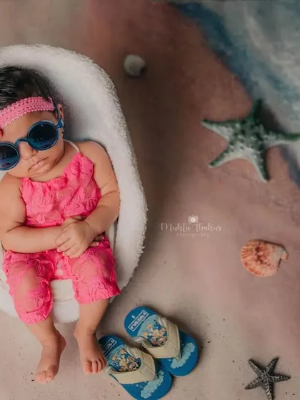 Soaking up the studio beach vibes. This is a perfect example of a creative and fun milestone session for your baby.