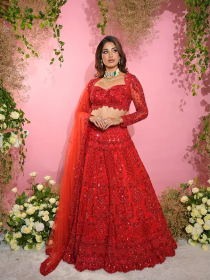 Another elegant pose showcasing the complete look. The soft waves in her hair and the glowing makeup come together for a truly memorable appearance.