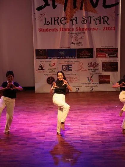 Dancers executing a coordinated leg-work sequence during their stage performance.