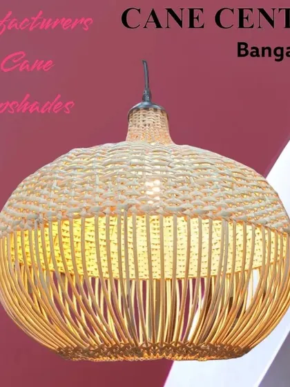 A close-up of one of our handcrafted pendant lampshades. This design features a tightly woven top section and a more open, airy base, creating a distinct pattern of light and shadow when illuminated.