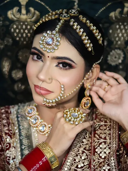This pose highlights the intricate jewelry and the flawless makeup application, showing the student's ability to create a polished and professional look.