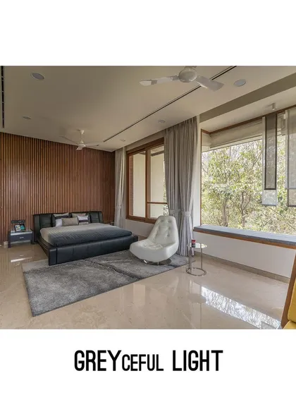 The "Greyceful Light" concept for this bedroom focuses on soft, diffused natural light. Sheer blinds and a calm color scheme create a serene and restful environment, framed by large windows overlooking the trees.
