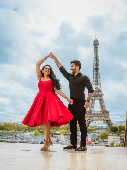 A playful dance in front of the Eiffel Tower.
