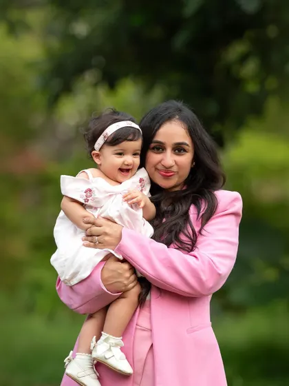 Such a happy duo! The genuine smiles from both mother and daughter make this outdoor portrait absolutely heartwarming.