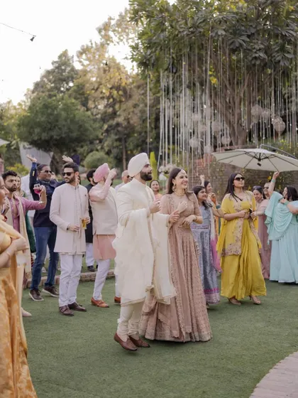The groom's grand entry with his family and friends, a moment of pure celebration on the lawns.