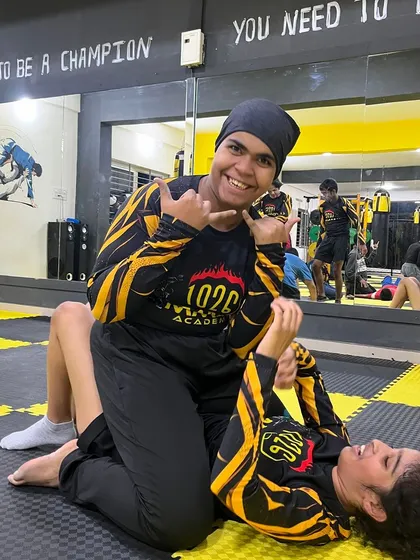 All smiles during a BJJ roll. While the training is tough, we always maintain a positive and supportive atmosphere on the mats.