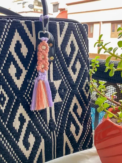 This keychain features a beautiful floral knot design, perfect for anyone who loves flowers. It's a small but intricate piece that makes a lovely, thoughtful gift.