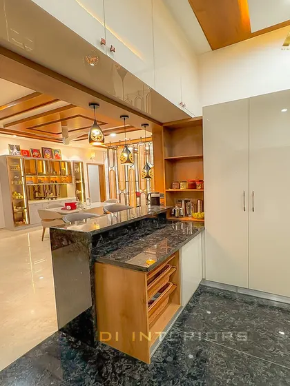 A view from the kitchen looking out into the dining area. The design includes a tall unit for storage and a breakfast bar that connects the two spaces.