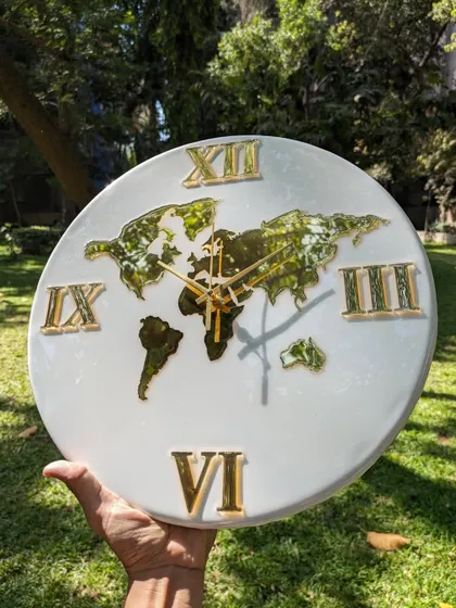 This world map wall clock features a green and gold foil map set against a clean white resin base. The large golden Roman numerals give it a classic and grand feel, perfect for a statement piece in a living room or office.