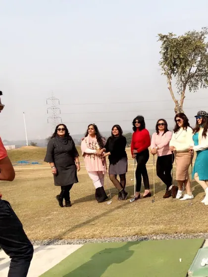 A corporate group gets ready for their first lesson. I ensure a welcoming environment where everyone, regardless of skill level, feels comfortable picking up a club.