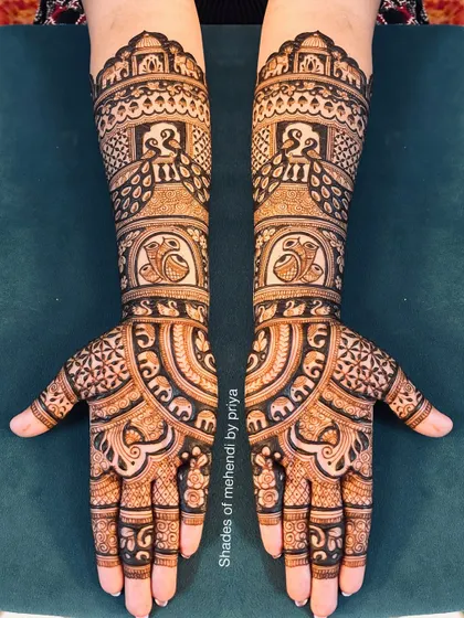 A very dense and intricate full bridal design. This pattern is filled with peacocks, elephants, and complex geometric fills for a truly grand statement.