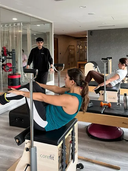 Strengthen your core, elevate your mind, and find your flow. A client demonstrates a teaser on the Wunda chair.