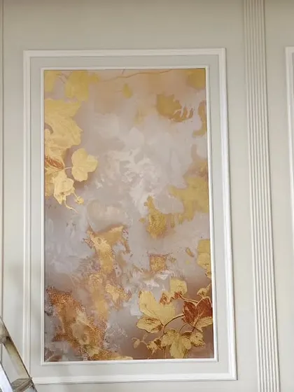 A set of three panels with golden leaf wallpaper, installed to look like framed art. This requires precise measurement and placement.