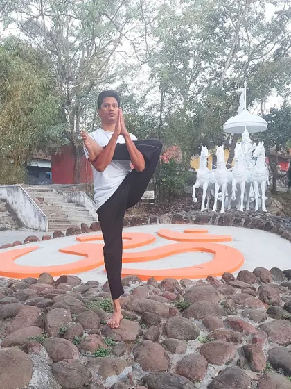 In this standing balancing pose before the sacred AUM symbol, I demonstrate how yoga practice boosts our immunity. By lowering stress hormones and improving organ function, yoga fortifies the body's natural defenses.