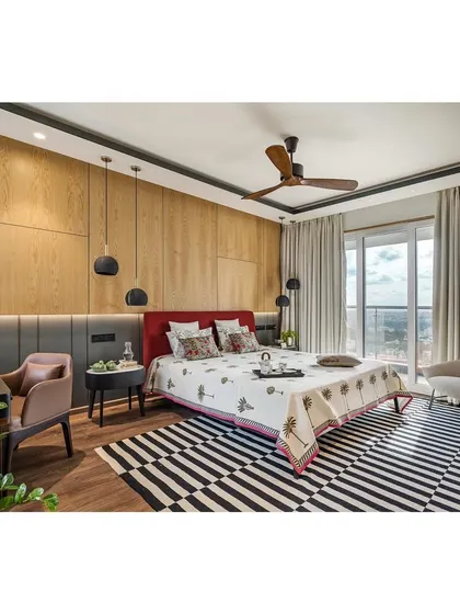 The master bedroom in apartment 5212, a minimal and serene space. A private dressing nook is cleverly screened by the wardrobe, and a light timber-paneled wall with brass inlays adds a touch of warmth and luxury.