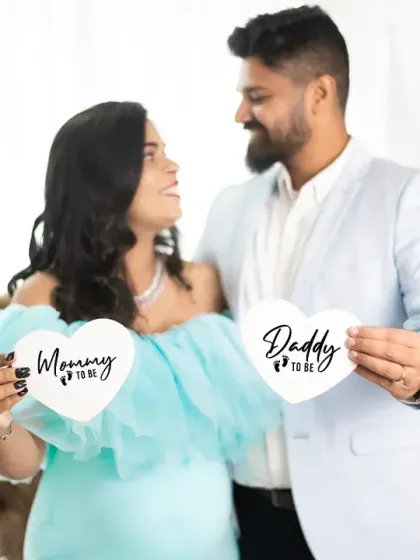 Announcing the journey to parenthood with cute, heart-shaped 'Mommy to be' and 'Daddy to be' signs. This is a fun way to add a personal touch to your maternity announcement photos.