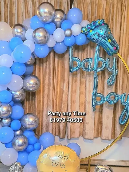 A close-up of the circular balloon arch for the "Welcome Baby Boy" party.