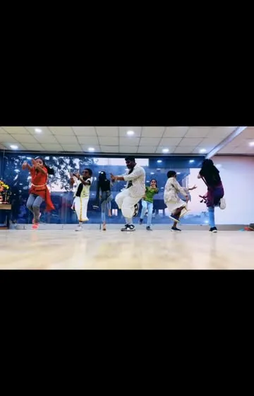 A dynamic shot from a group performance, capturing the energy and movement of the choreography.