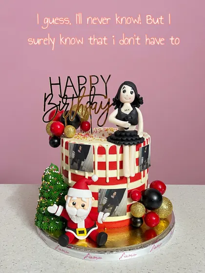 A fun and quirky Christmas-themed birthday cake. This design features a custom fondant figurine, a Santa Claus, and edible photo frames, showing how personal and unique a cake can be.