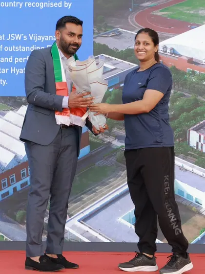 A dignitary is welcomed with a bouquet at the H16 Sports event in the UAE.