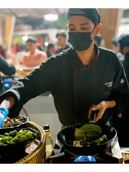 Another view of our live wok station, where a chef adds ingredients to the pan, ready to create a custom dish for a guest.