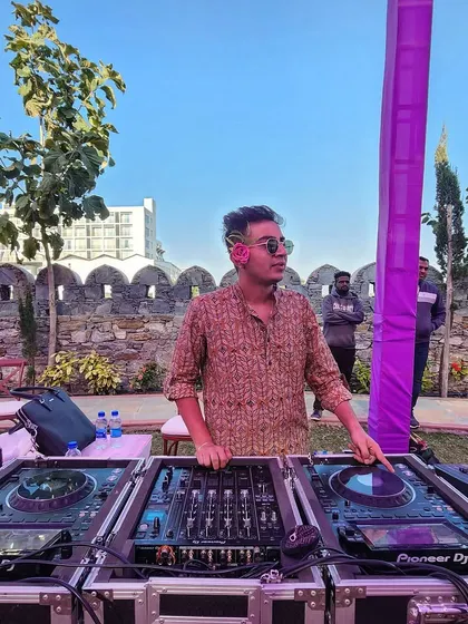 DJing outdoors at a beautiful venue in Udaipur. I adapt my music style to fit the daytime vibe, creating a relaxed yet energetic atmosphere perfect for a Haldi or Mehendi.