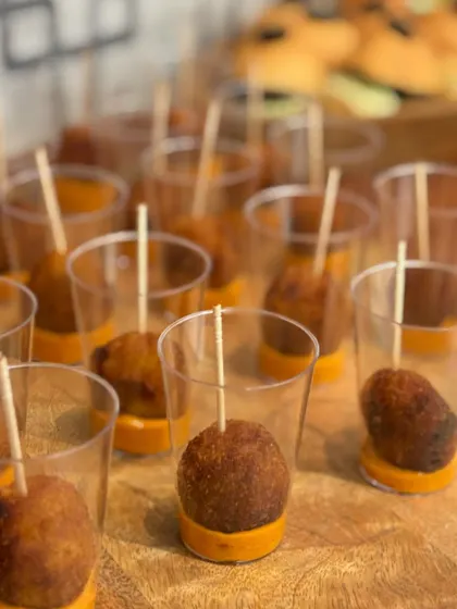 Quinoa Cheese Balls served in individual shot glasses with a dip at the bottom. This is a healthier, gluten-free option that doesn't compromise on flavor.
