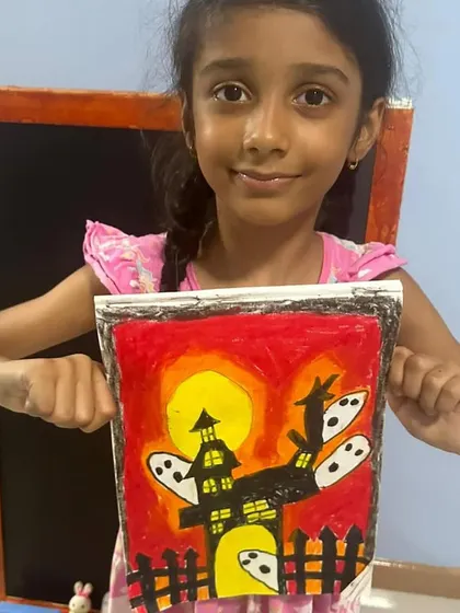 This student's Halloween art has a dramatic red sky, making the ghostly figures pop. It's amazing to see their imaginations come to life.