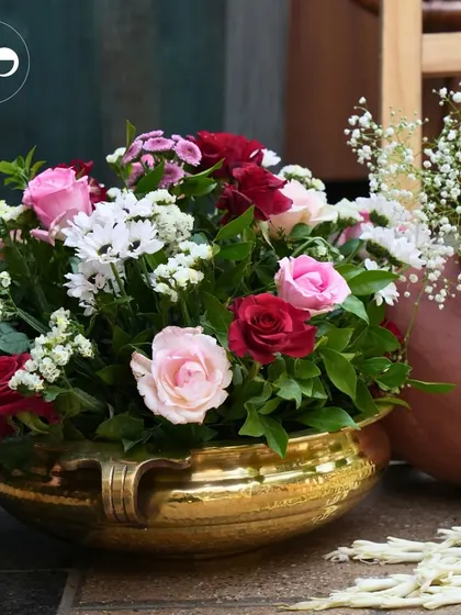 For a traditional 'Seemant' ceremony, we used classic decor elements like hammered brass bowls filled with beautiful pink and red roses. This created an atmosphere of timeless elegance and warmth.