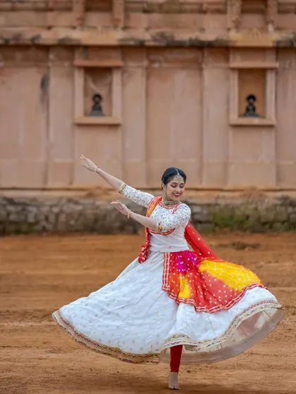 A graceful solo pose, with the anarkali in full flight. The costume is truly a partner in the dance, adding to the beauty of every movement.