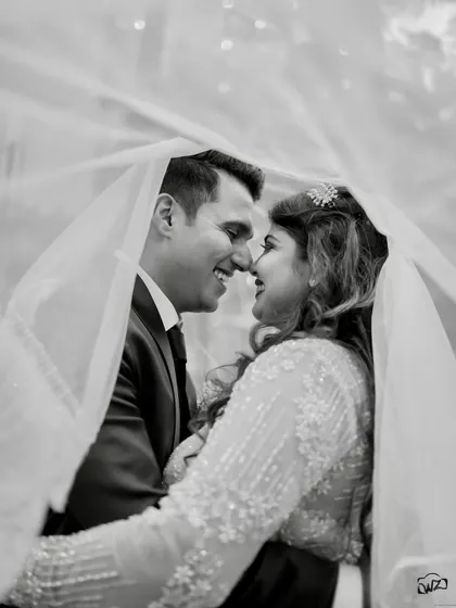 A timeless black and white portrait. This classic shot under the veil captures the intimacy and romance of a Catholic wedding, showing our ability to create artistic and elegant images.