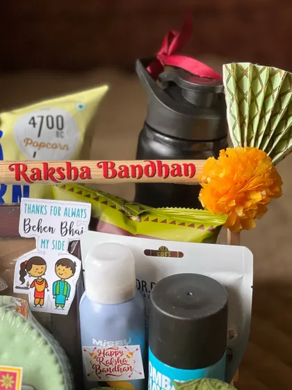 A close-up showing the "Raksha Bandhan" branding on the wooden crate and the "Thanks for always being by my side" sticker.