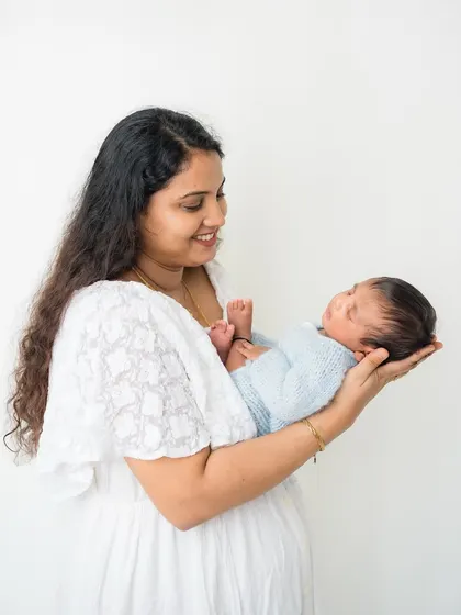 A mother holds her newborn in the palm of her hand, highlighting just how tiny and precious they are.