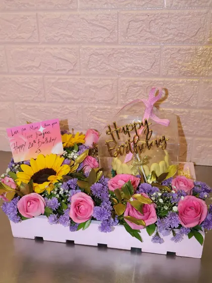 A beautiful birthday hamper combining a custom mini cake with a stunning arrangement of fresh sunflowers and roses. It's the perfect all-in-one gift to make someone's day extra special.