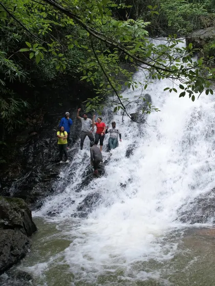 Climbing and posing on the rocks of a waterfall. It's all about finding your own adventure and having fun in a safe way.