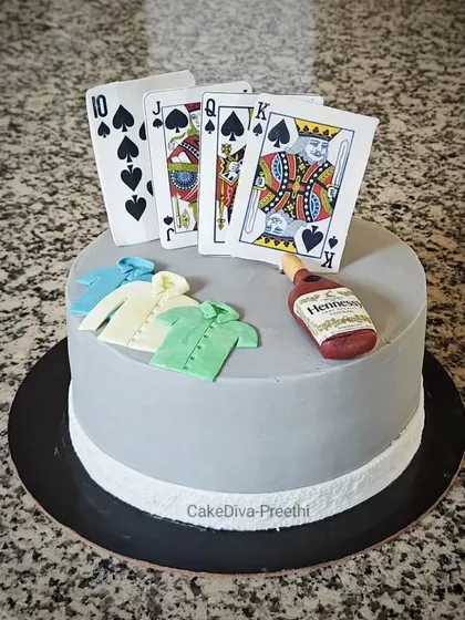 Another look at the poker-themed cake. The sharp, clean lines of the grey buttercream provide a great contrast for the colorful fondant toppers.