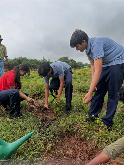Students work together in the mud and rain, their determination to restore the Aravali forest shining through.