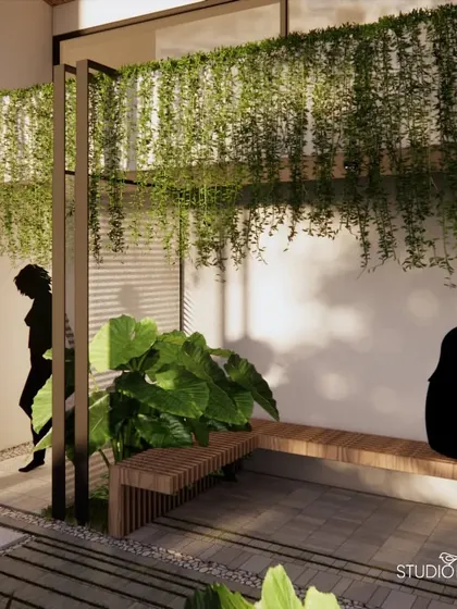 A quiet seating nook at the Pai Residence, featuring a simple wooden bench and a shower area framed by a metal pergola. This intimate space, surrounded by large-leafed plants, offers a private moment of pause within the larger landscape.