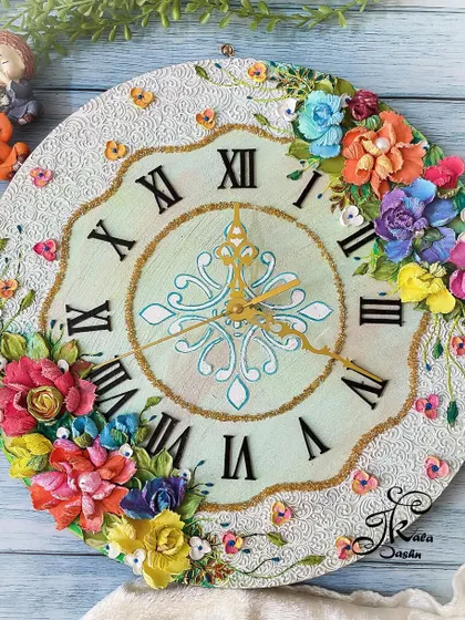 A beautiful 14-inch wall clock with a neutral, textured base and a vibrant bouquet of sculpted flowers. The golden hands and numerals add a touch of warmth and elegance to the overall design.
