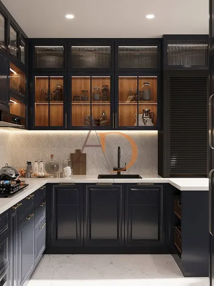 This U-shaped modular kitchen showcases a sophisticated blend of rich navy blue PU-finished cabinetry and warm wood tones. Features like fluted glass shutters, under-cabinet LED lighting, and a clean white quartz countertop demonstrate a perfect balance of luxury and high-functioning kitchen design.