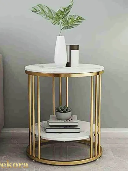 This side table features a simple yet elegant design with nine straight metal rods forming its cylindrical gold-finish frame. The two white surfaces are ideal for holding books, plants, and other decorative accents.