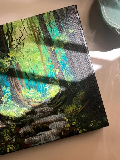 The "Dreamland" painting with sunlight casting shadows across the canvas, adding another layer of depth to the scene.