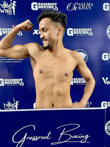 A smile and a flex. This fighter is ready to put on a show.