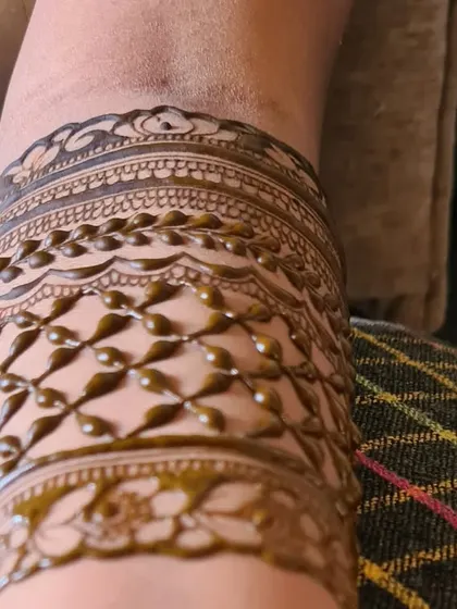 Another detail shot of a baby shower henna design, highlighting the raised texture of the freshly applied henna paste.