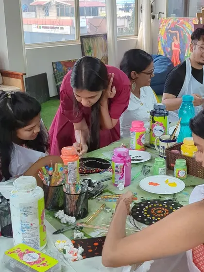 Participants engrossed in a dot mandala workshop. The shared focus and quiet creativity make for a very calming atmosphere.