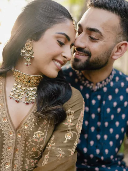 A close-up, intimate portrait of a couple in Bali, capturing their affection and the beautiful details of the bride's jewelry.