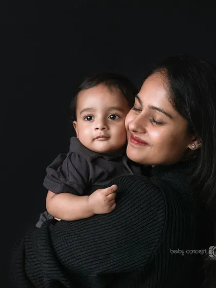 A tender moment between a mother and her baby. These simple, elegant portraits against a dark background are timeless and highlight the deep connection you share.