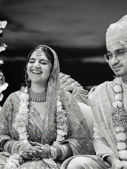 Another angle of the bride's happy laughter, with the groom looking on with a gentle smile. These are the unposed moments that hold the most meaning.