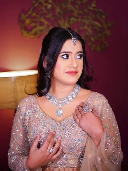 A close-up of the pastel peplum lehenga, showing the beautiful silver jewelry it pairs with.