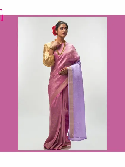 This full-length portrait shows the graceful drape of the pink and lavender silk linen saree, an embodiment of timeless elegance.